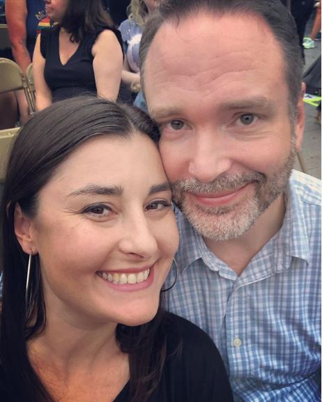 Josh Van Valkenburg in blue shirt taking selfie with Jenny Gill